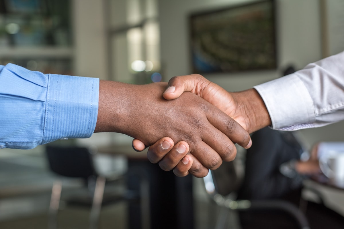 Two professionals shaking hands after a meeting